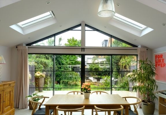 steel look sliding glass doors with glazing bars and gable end windows and rooflights