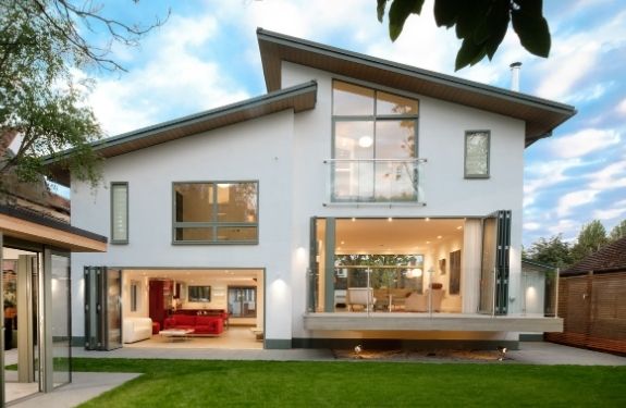 contemporary architecture with uneven slanted roofing and a floating terrace with aluminium bifolding doors and a contemporary Juliet balcony design 