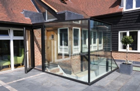 small glass box extension created using Invisio structural glazing and an aluminium casement door small glass box extension created using Invisio structural glazing and an aluminium casement door